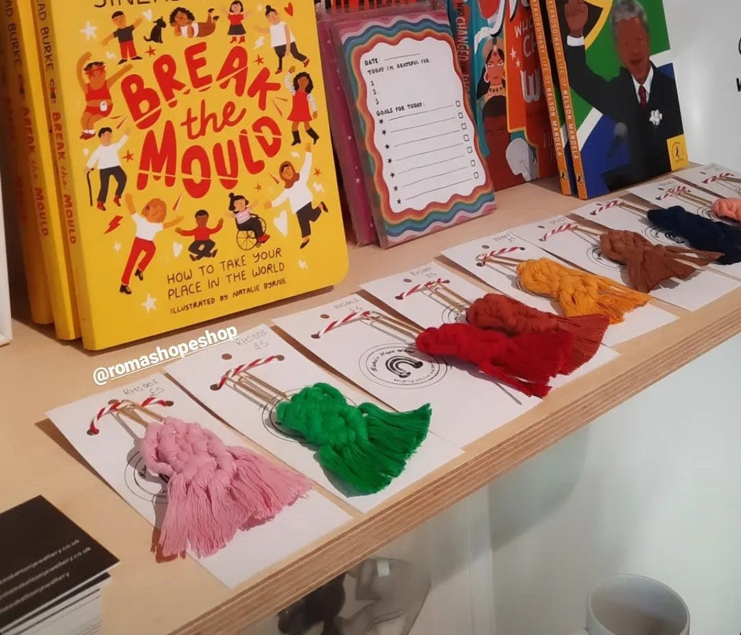 Display of books and stationery items on a shelf with promotional text overlay.