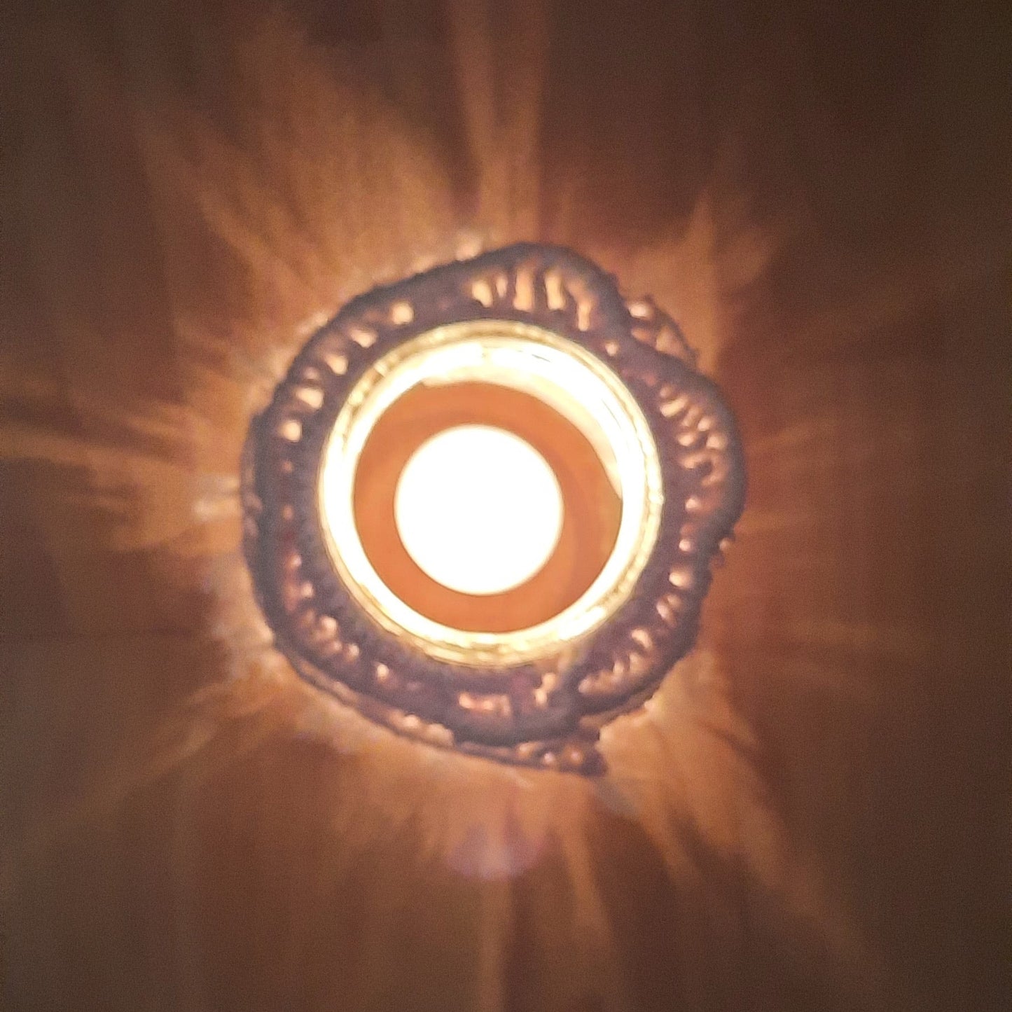 Decorative light fixture with a warm glow on a dark background