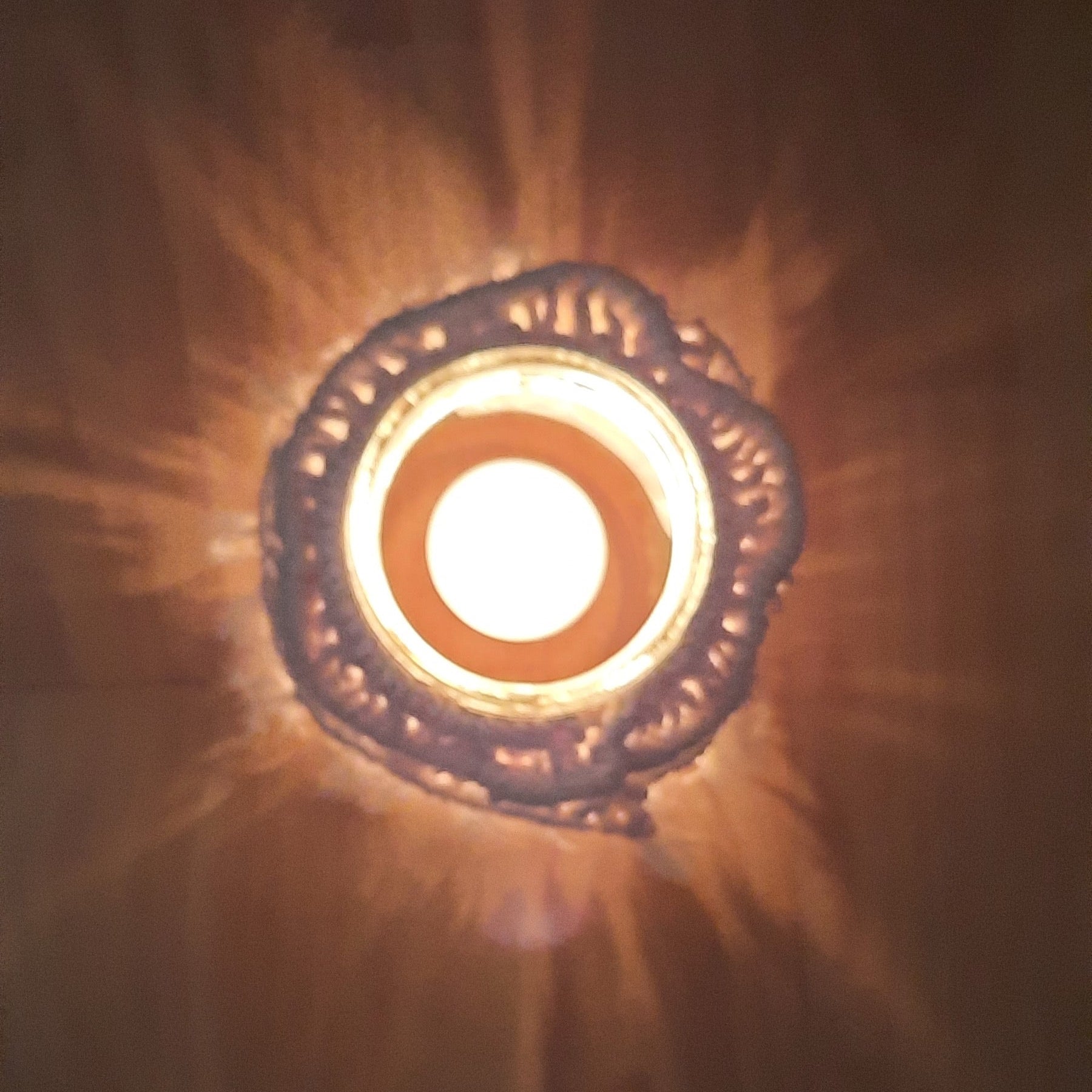 Decorative light fixture with a warm glow on a dark background