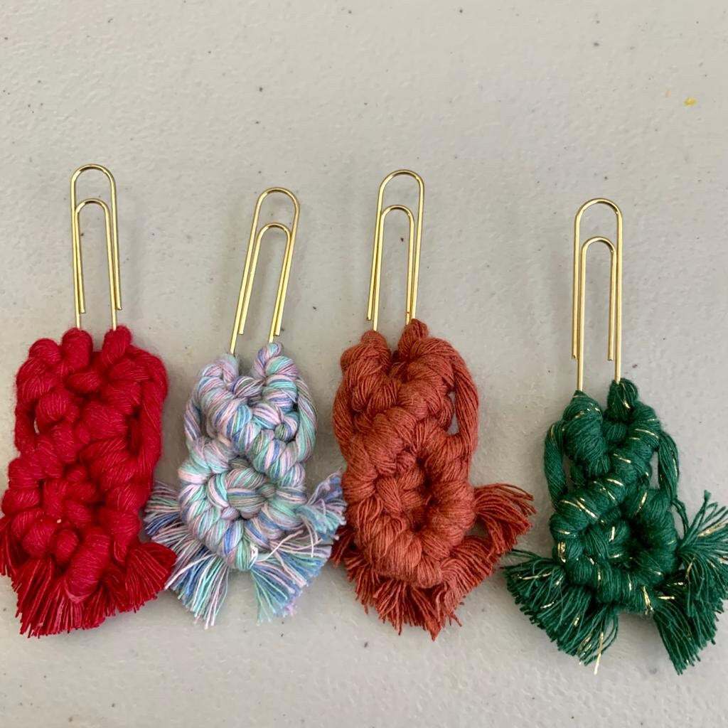 Four colorful yarn bookmark paperclips  on a light gray backgroynd