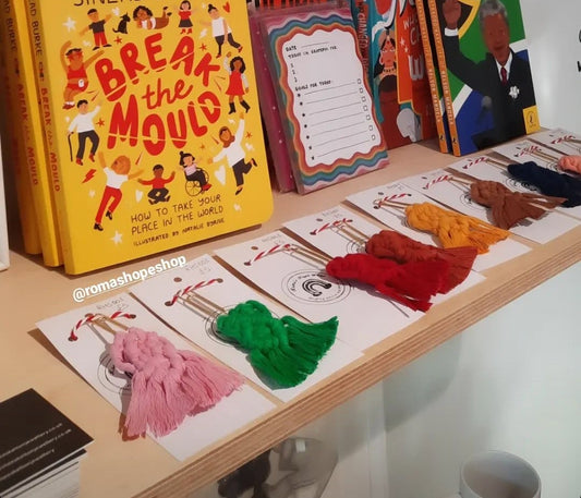 Display of books and stationery items on a shelf with promotional text overlay.